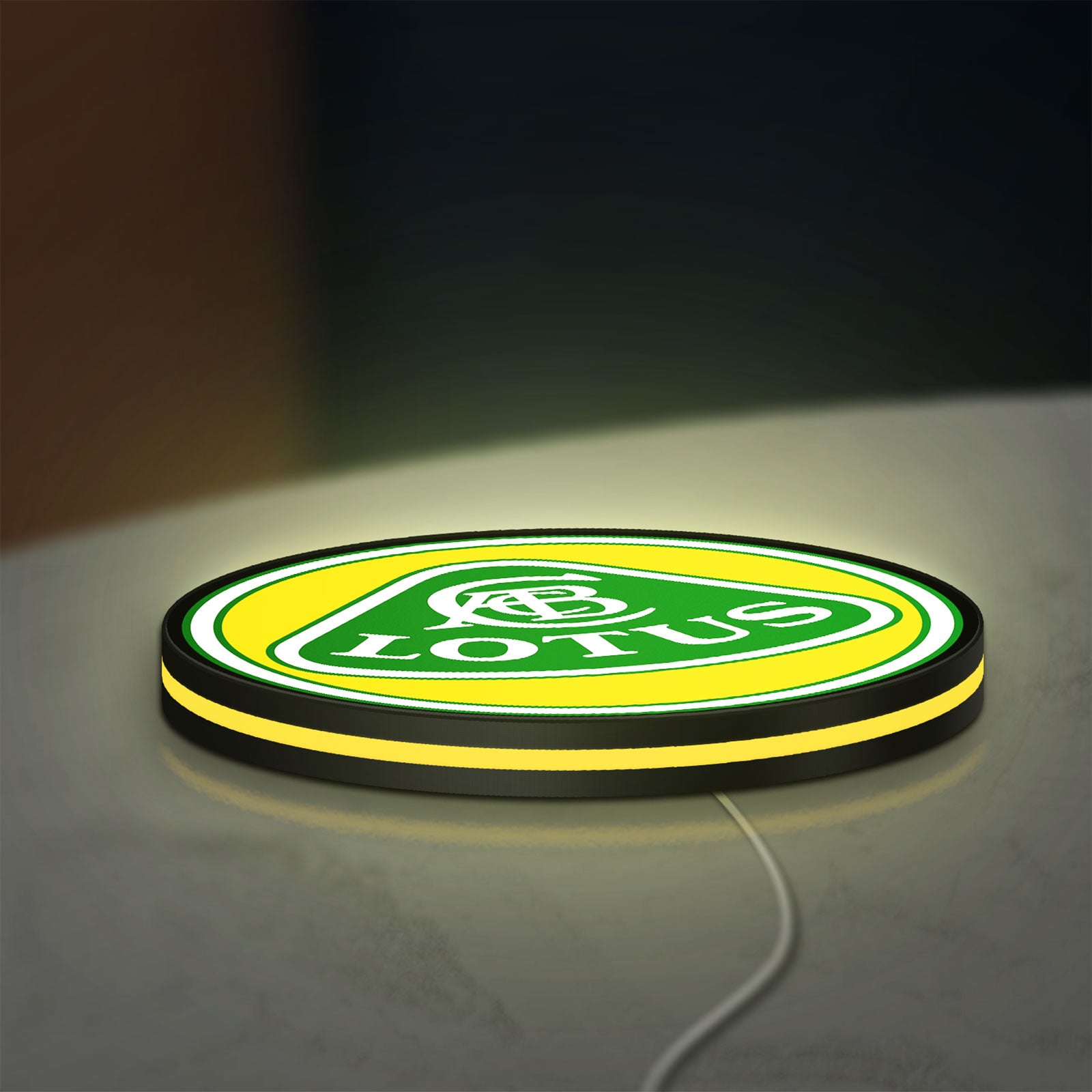 Lotus Cars LED lightbox lying flat on a desk with yellow glow
