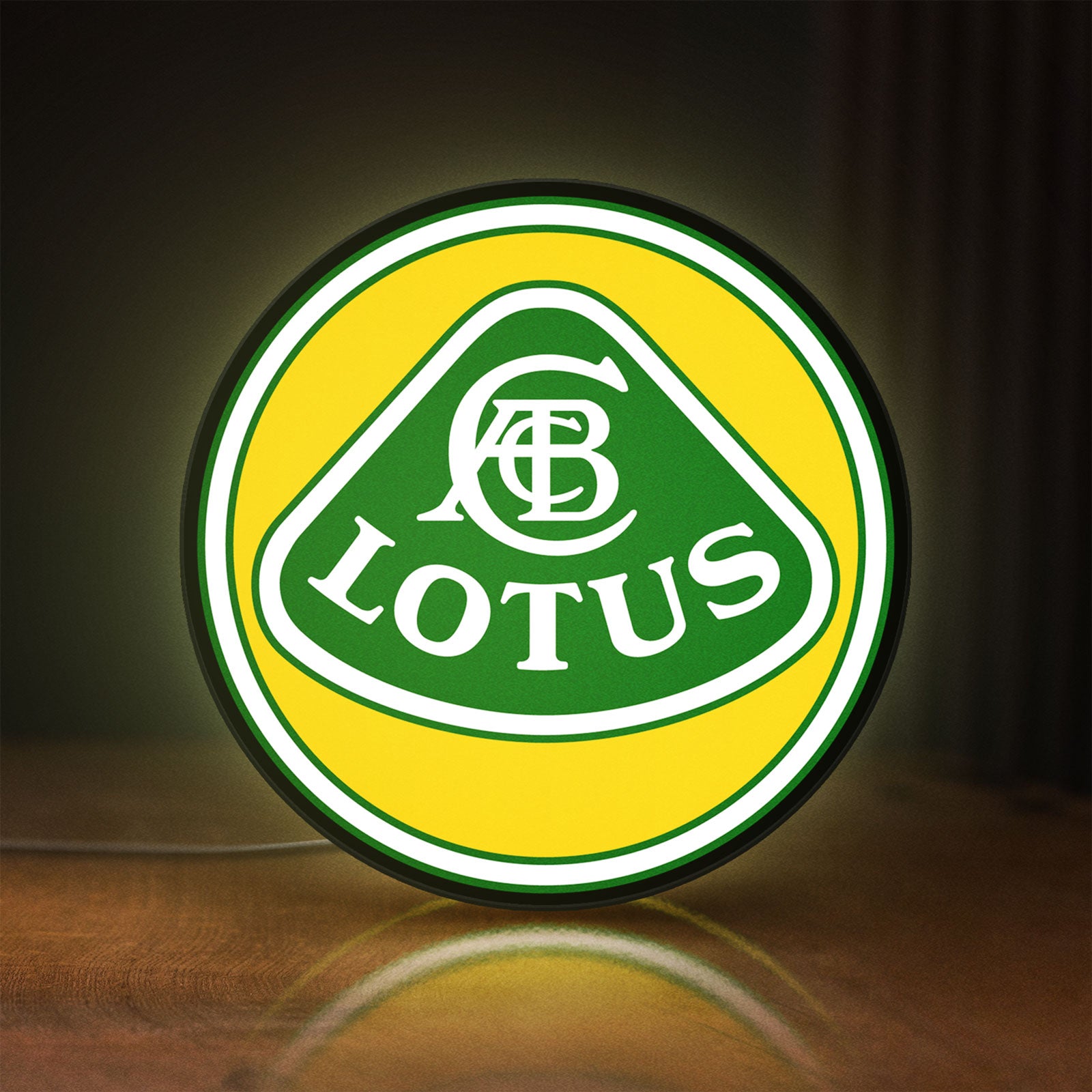 Front view of Lotus Cars LED lightbox sign glowing on a wooden desk