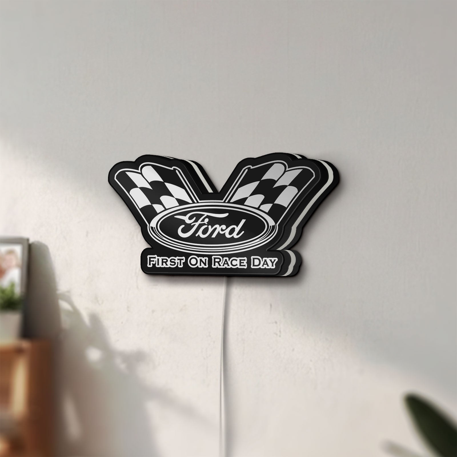 Unlit Ford Racing LED lightbox mounted on a wall in daylight