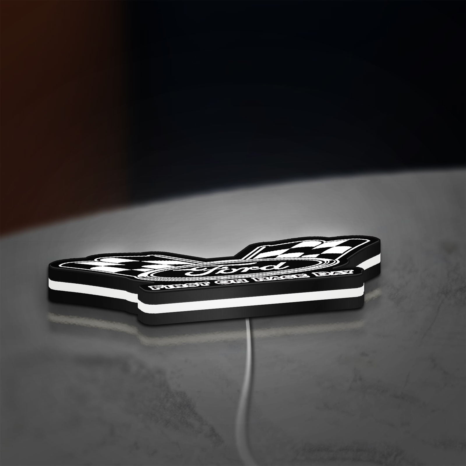 Ford Racing LED lightbox lying flat on a desk with white glow