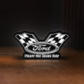 Front view of Ford Racing LED lightbox sign glowing on a wooden desk