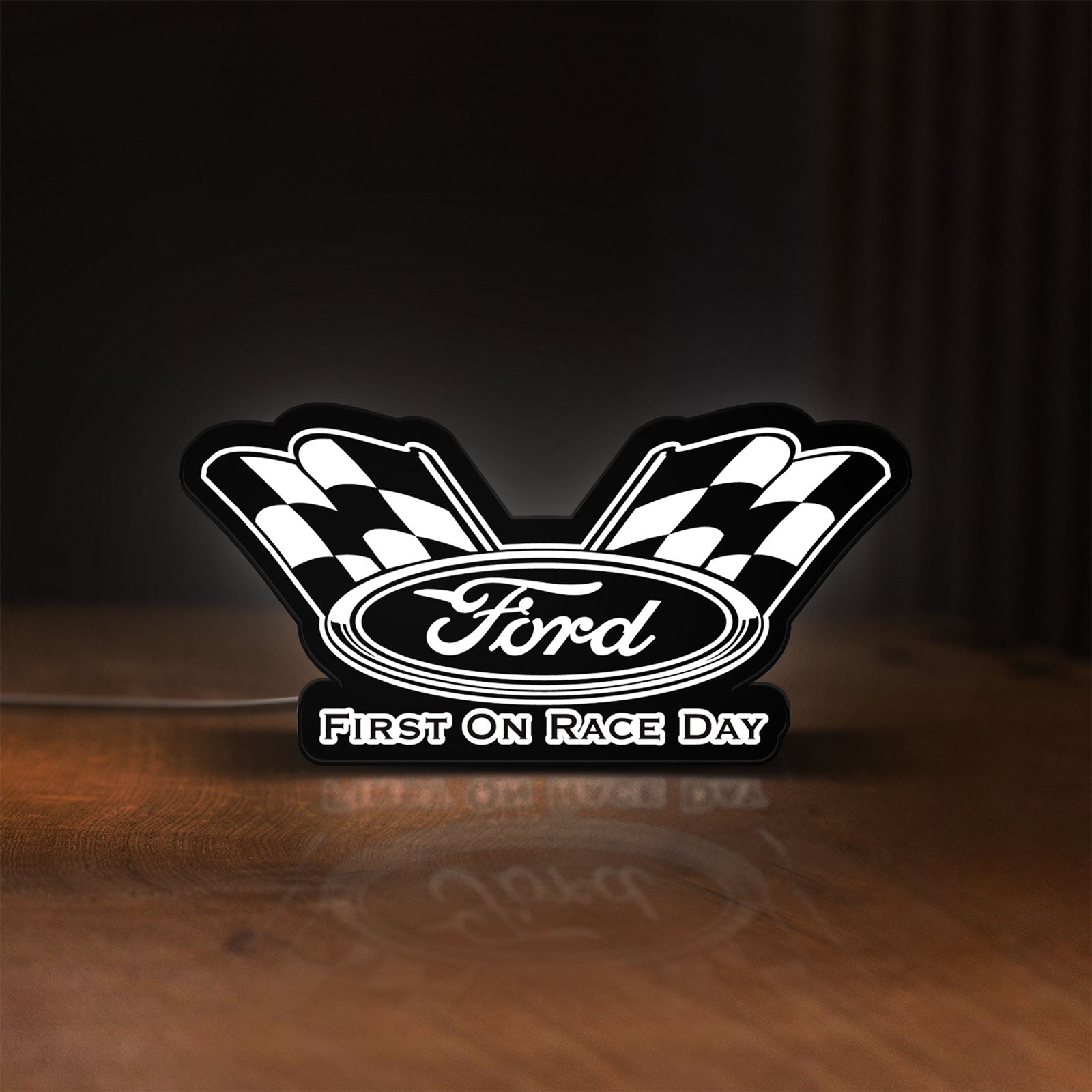 Front view of Ford Racing LED lightbox sign glowing on a wooden desk