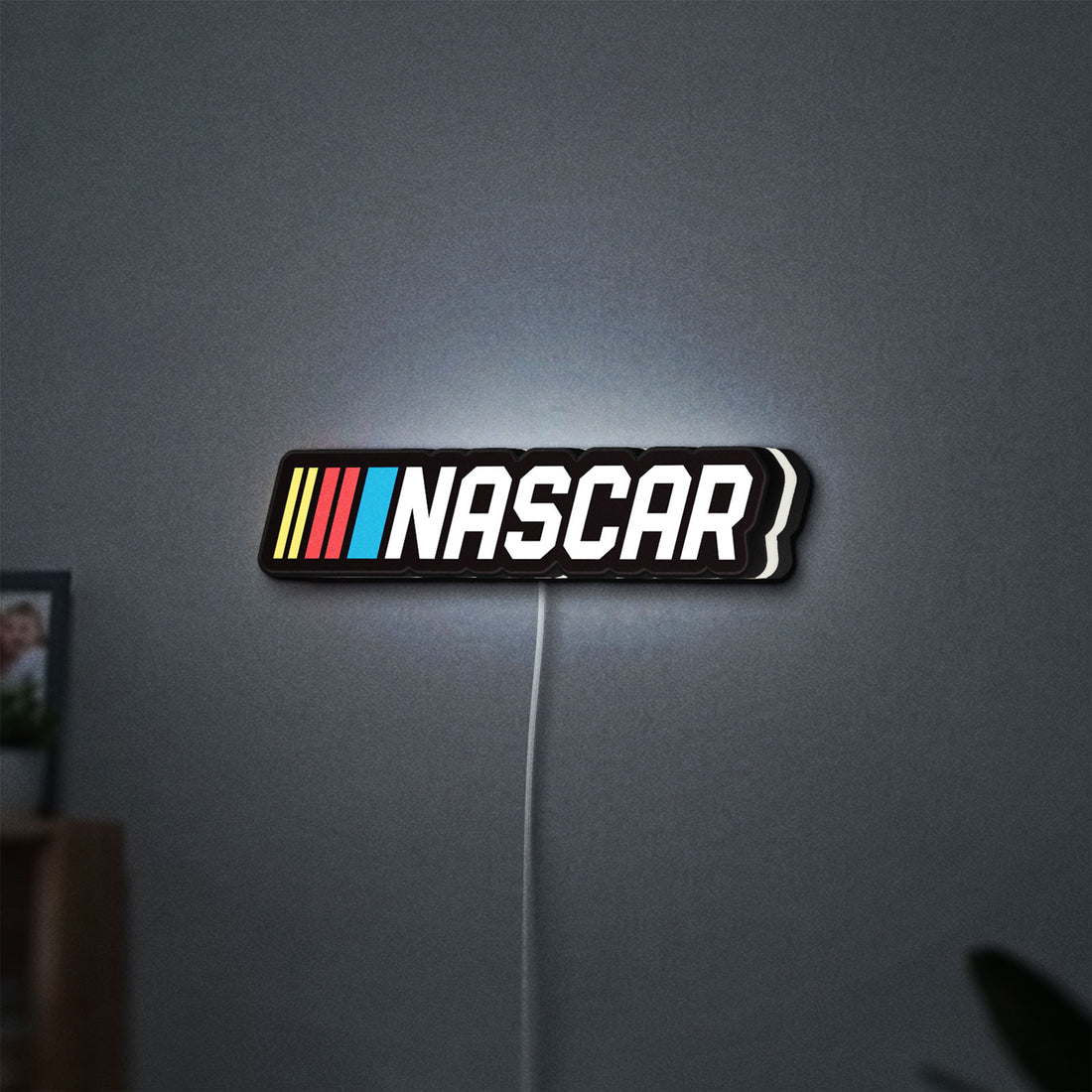 NASCAR LED lightbox hanging on a wall with white glow