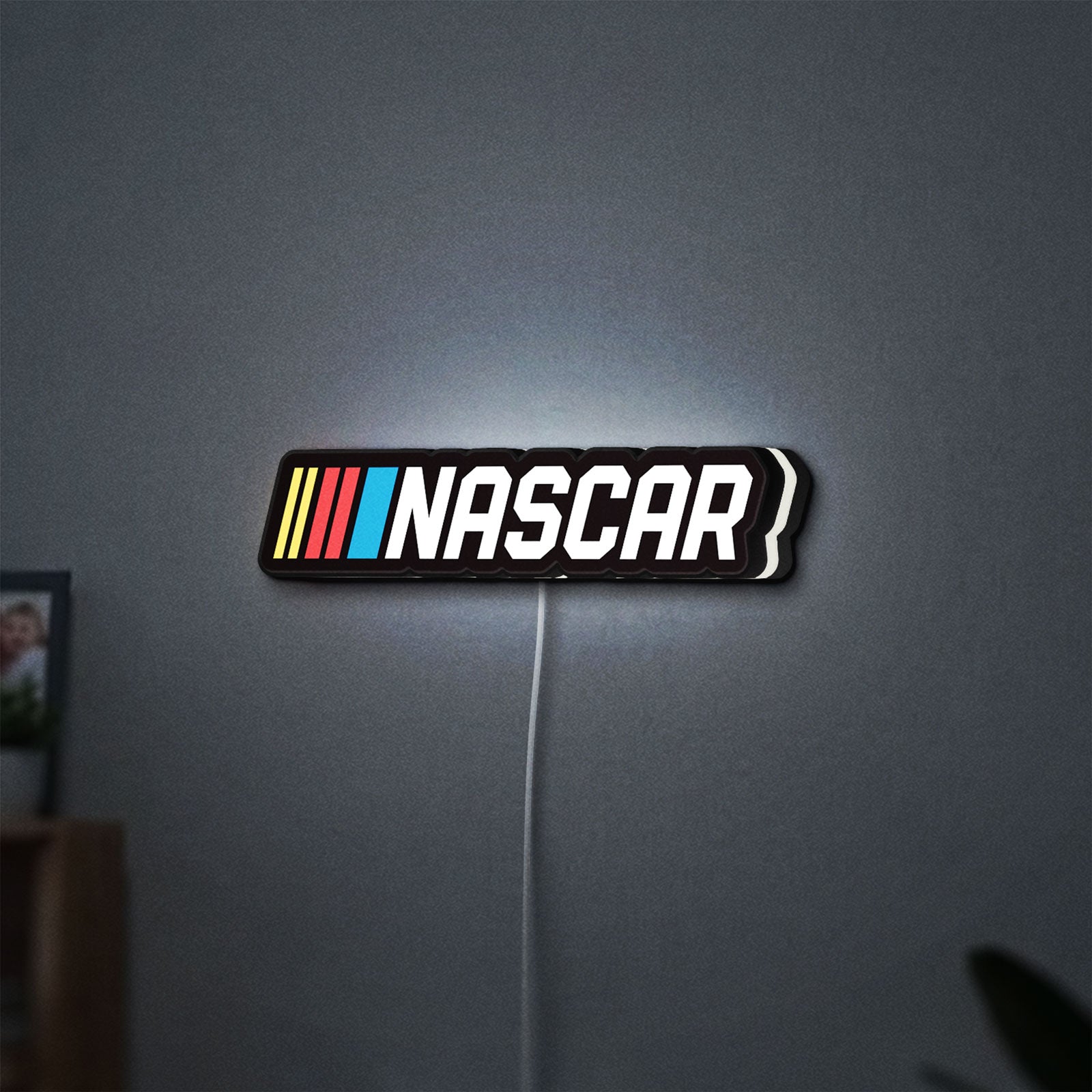 NASCAR LED lightbox hanging on a wall with white glow