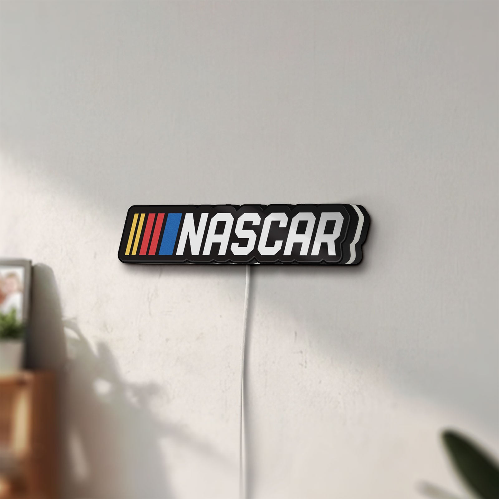 Unlit NASCAR LED lightbox mounted on a wall in daylight