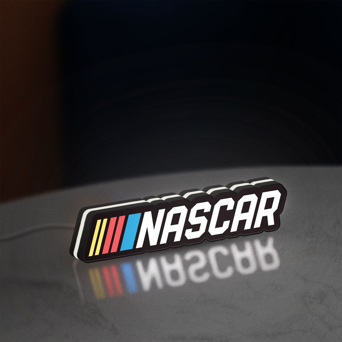 NASCAR LED lightbox hanging on a wall with white glow