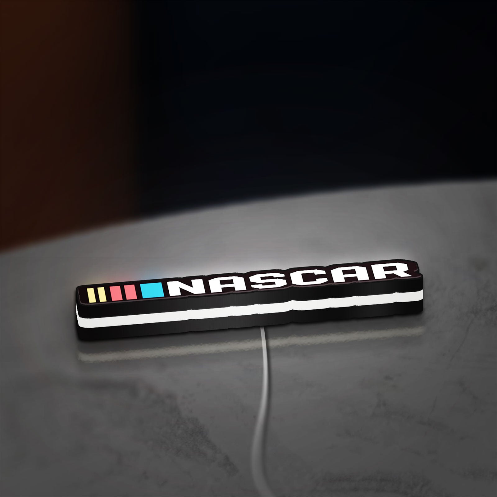 NASCAR LED lightbox lying flat on a desk with white glow