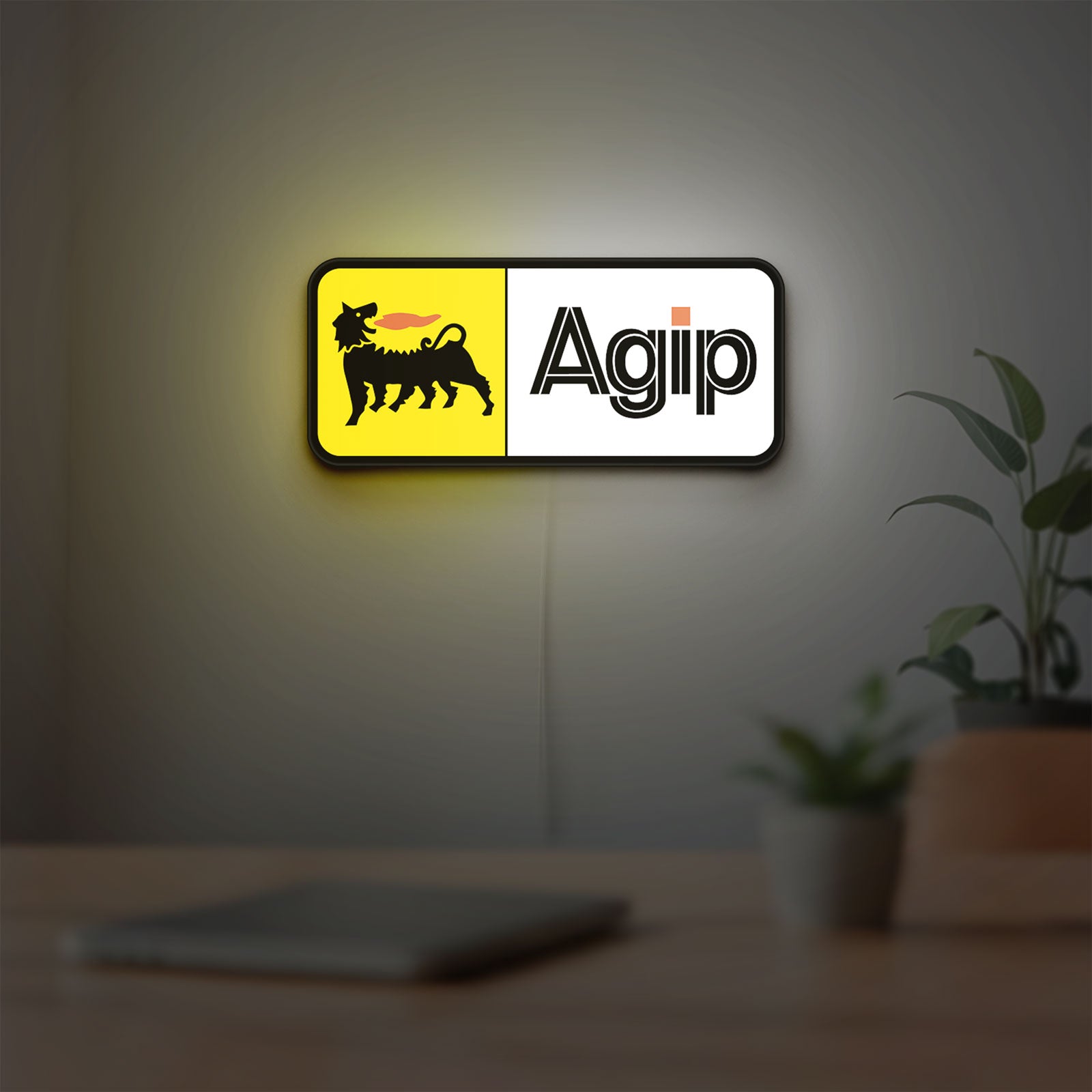 Agip Six-Legged Dog LED lightbox hanging on a room wall with soft yellow light