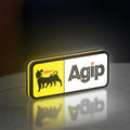 Agip Six-Legged Dog LED lightbox standing on a desk from an angled side view with yellow glow