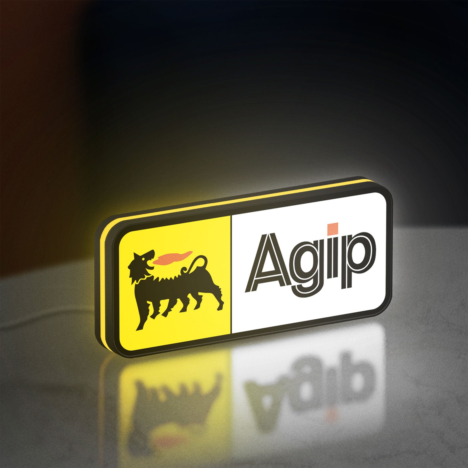 Agip Six-Legged Dog LED lightbox standing on a desk from an angled side view with yellow glow
