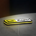 Agip Six-Legged Dog LED lightbox lying flat on a desk with yellow glow