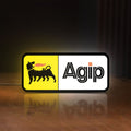 Front view of Agip Six-Legged Dog LED lightbox sign glowing on a wooden desk
