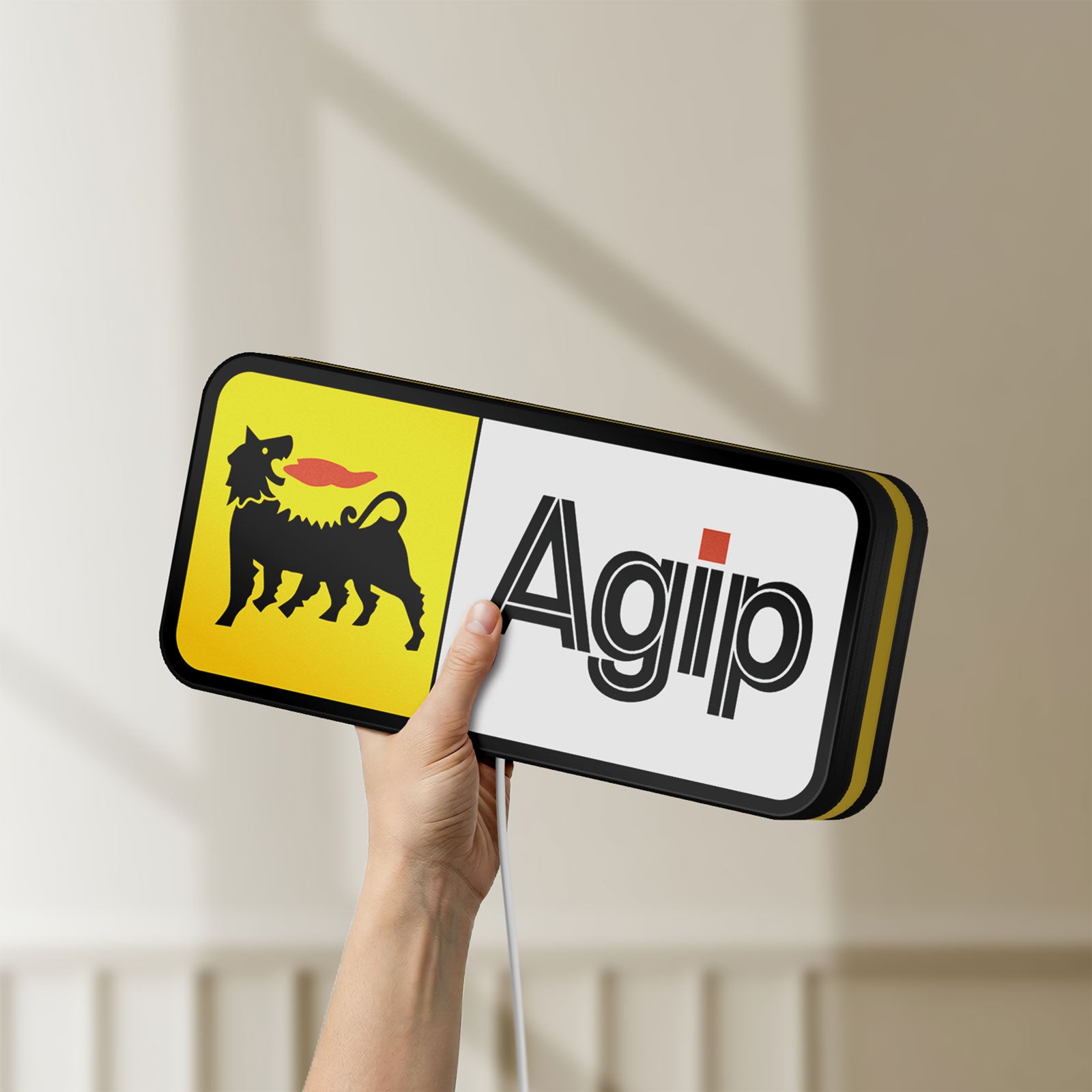 Unlit Agip Six-Legged Dog LED lightbox held by hand to show size and details