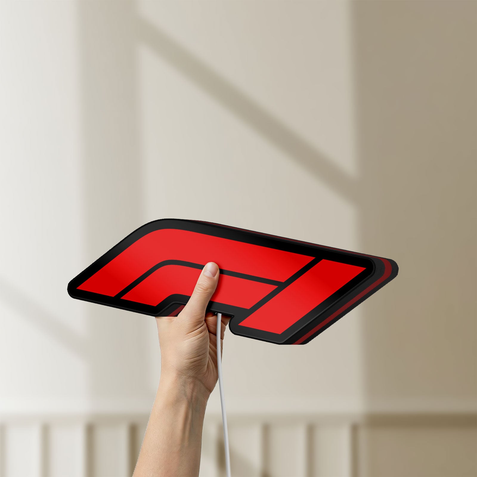 Unlit F1 2021 LED lightbox held by hand to show size and details