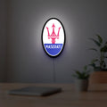 Maserati LED lightbox hanging on a room wall with soft white light