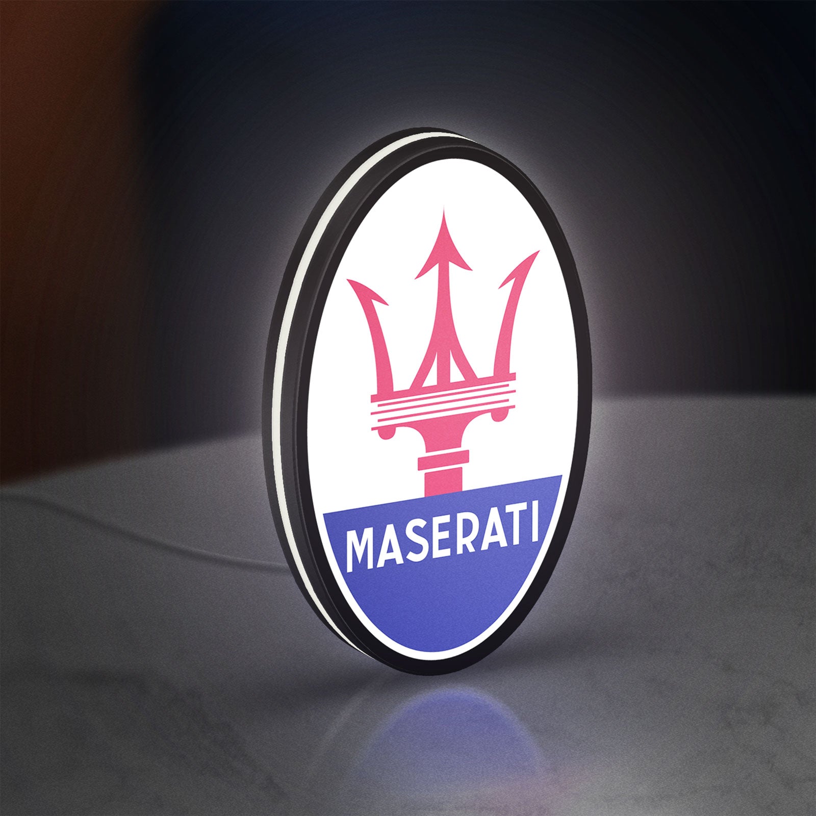 Maserati LED lightbox standing on a desk from an angled side view with white glow
