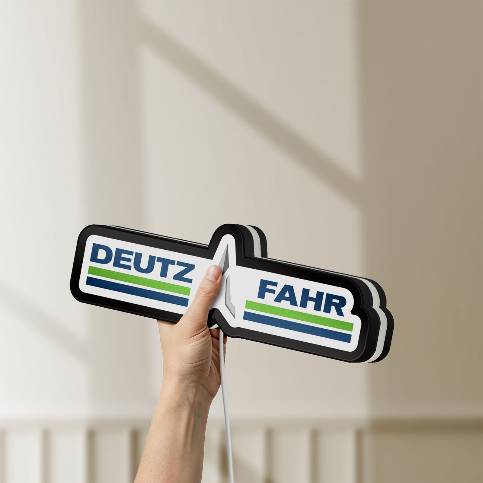 Unlit DEUTZ FAHR LED lightbox held by hand to show size and details