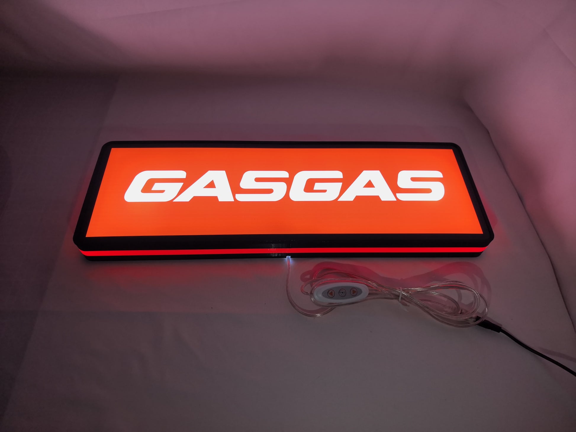 Gasgas LED Sign (50cm) - Illuminated flat lay angled view, unique wall art for desk and room decor