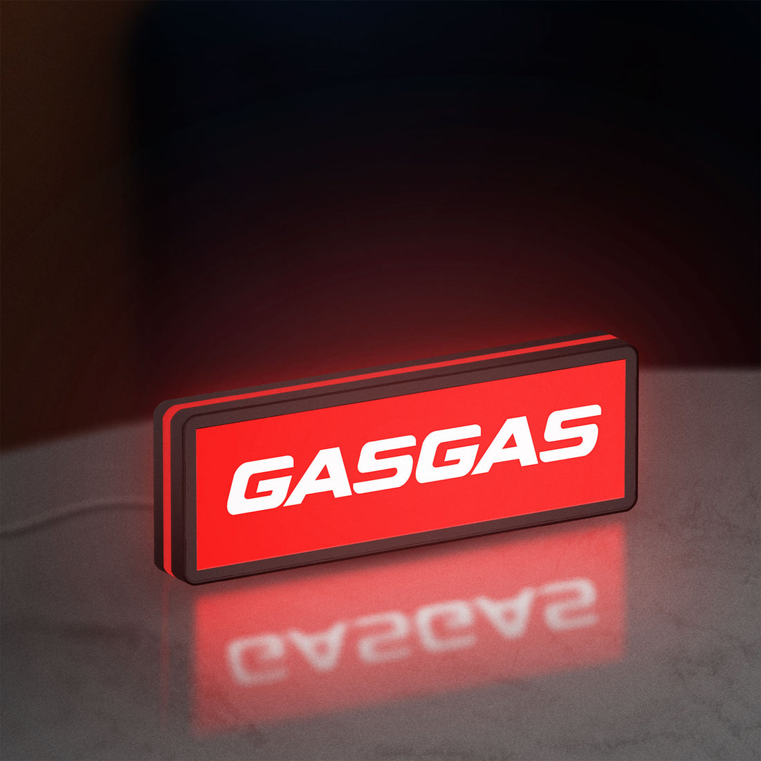 GasGas LED lightbox hanging on a wall with red glow
