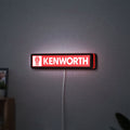 Kenworth LED lightbox hanging on a wall with red glow
