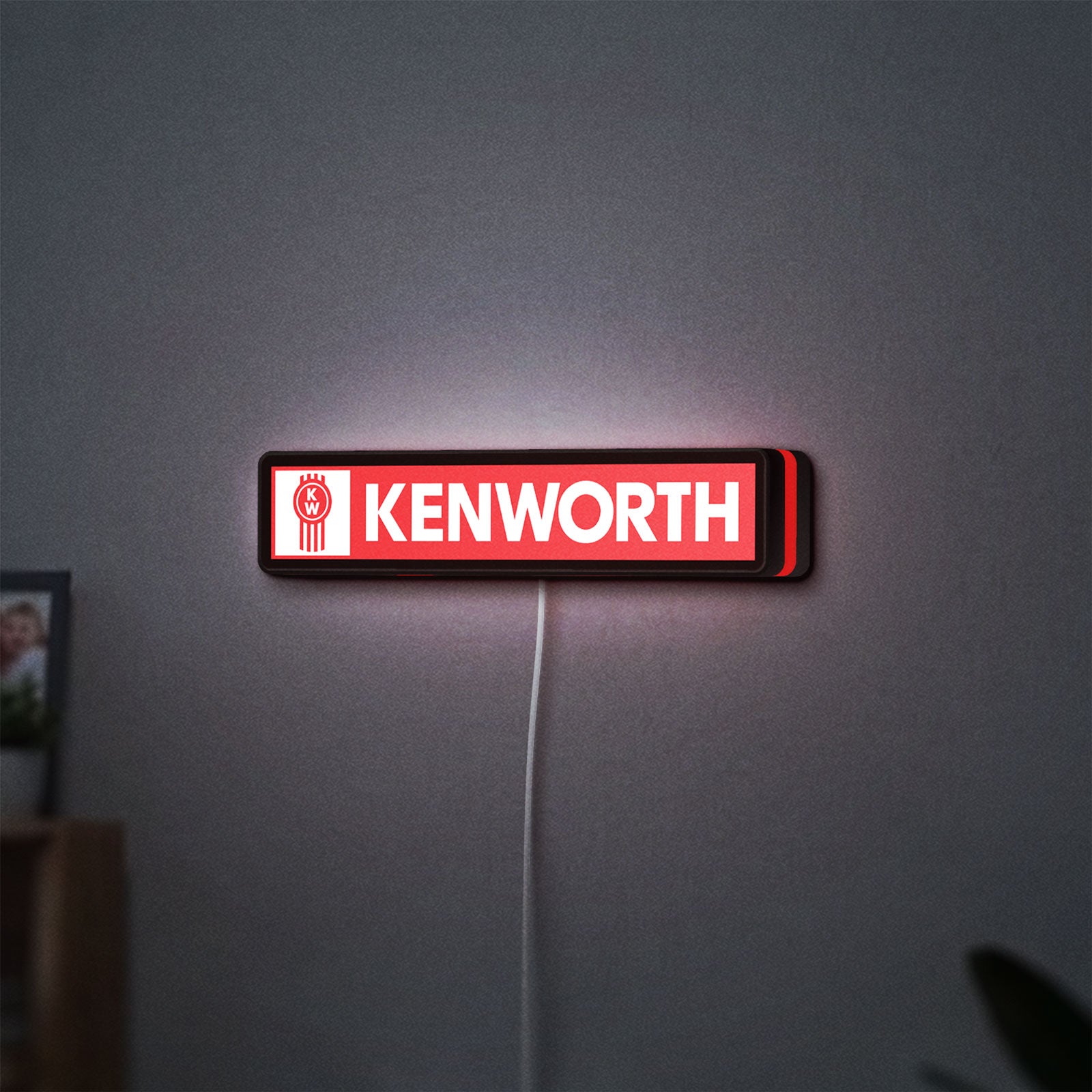 Kenworth LED lightbox hanging on a wall with red glow