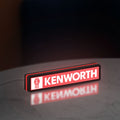 Kenworth LED lightbox standing on a desk from an angled side view with red glow