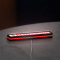 Kenworth LED lightbox lying flat on a desk with red glow
