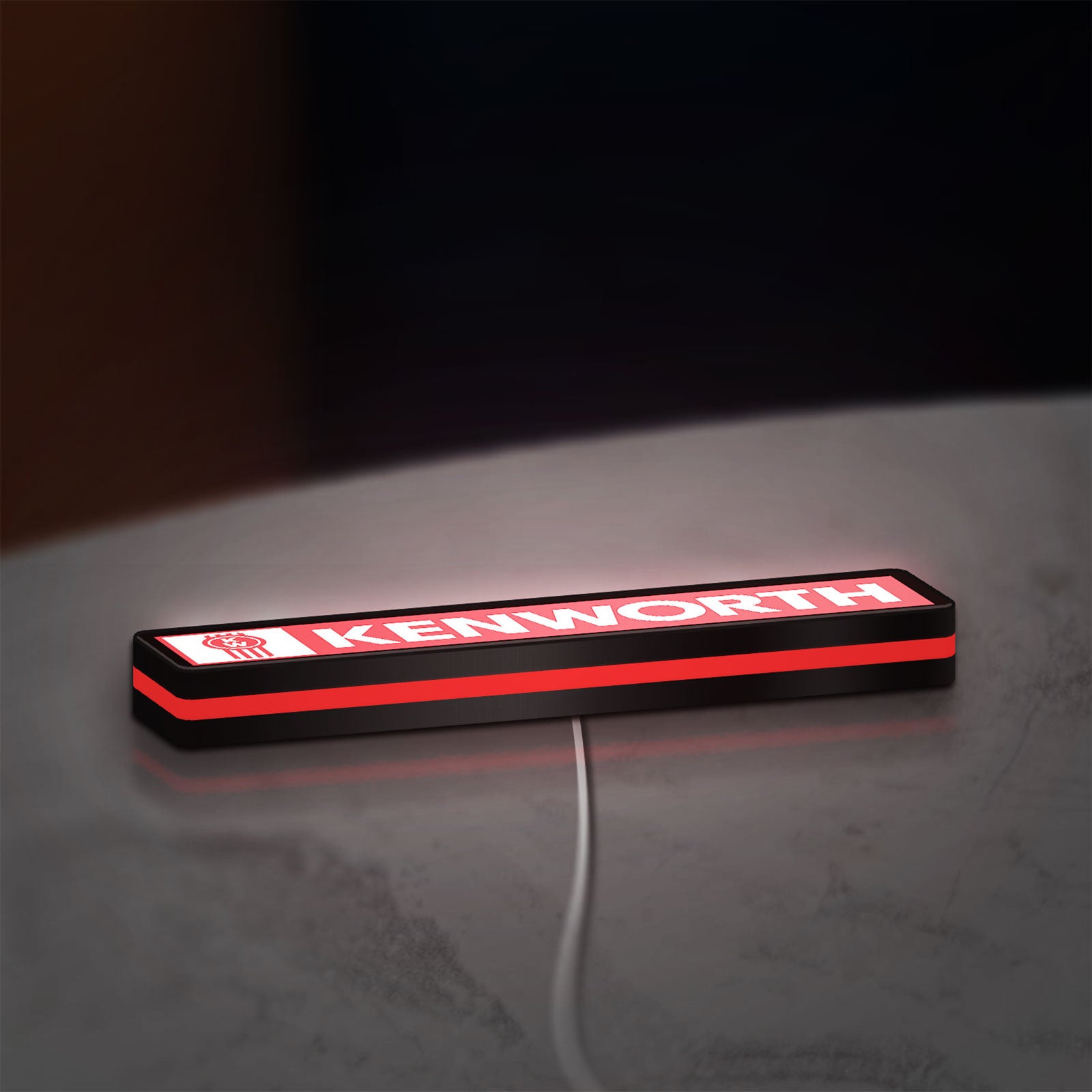 Kenworth LED lightbox lying flat on a desk with red glow