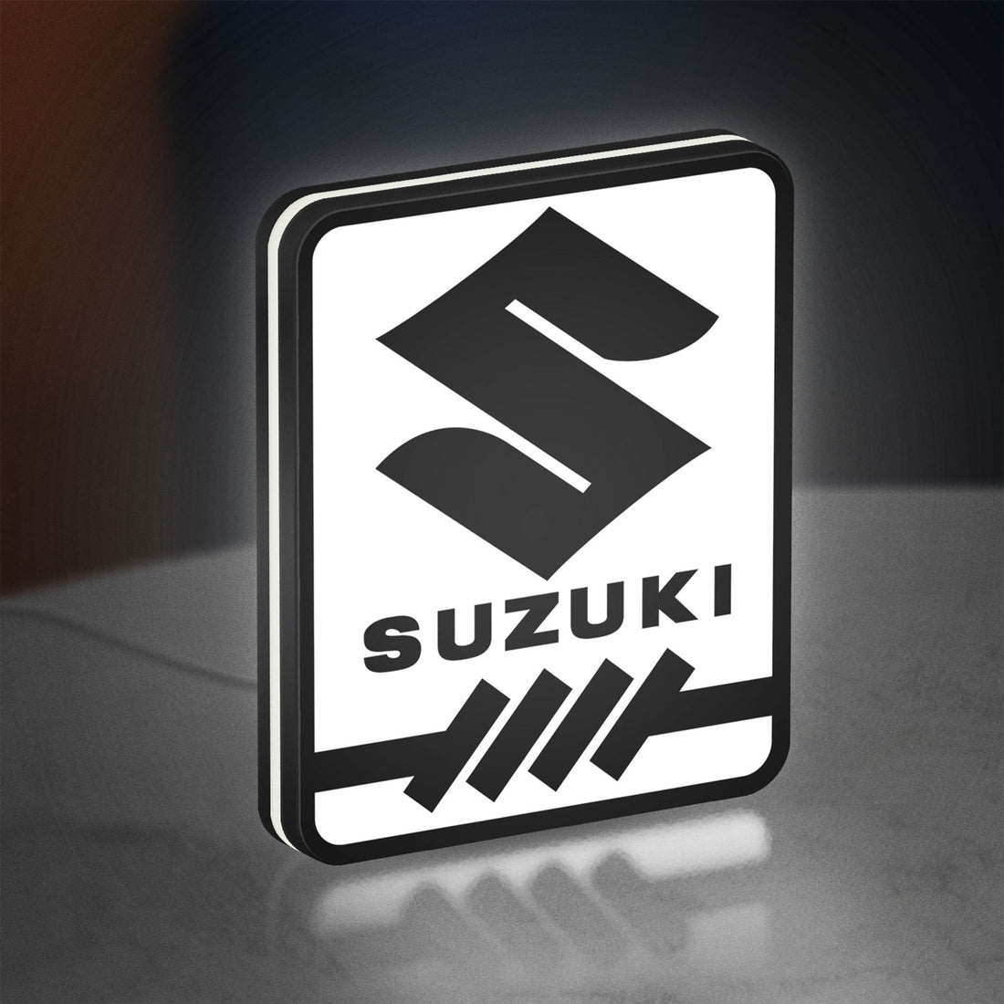 Suzuki LED lightbox hanging on a wall with white glow
