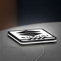 Suzuki LED lightbox lying flat on a desk with white glow