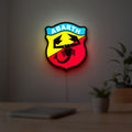 Abarth Scorpion LED lightbox hanging on a room wall with soft yellow light