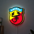 Abarth Scorpion LED lightbox hanging on a wall with yellow glow