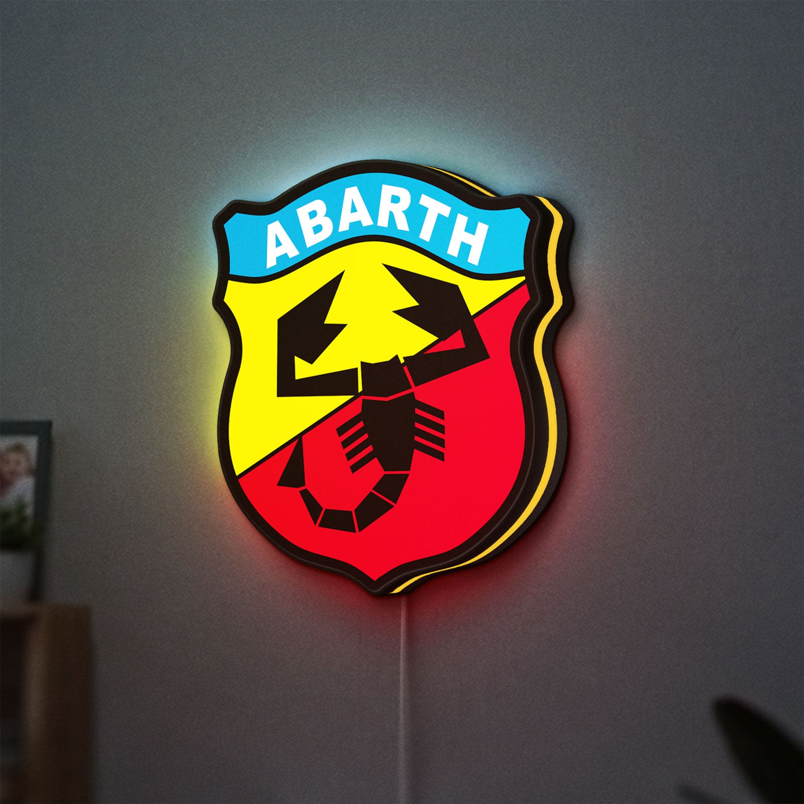 Abarth Scorpion LED lightbox hanging on a wall with yellow glow