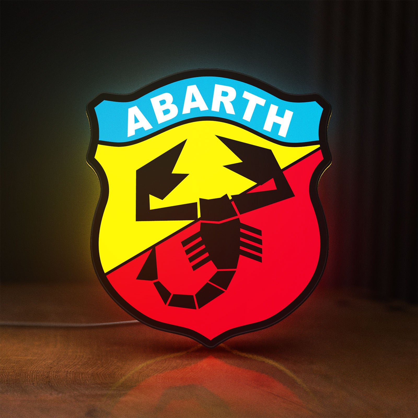 Front view of Abarth Scorpion LED lightbox sign glowing on a wooden desk