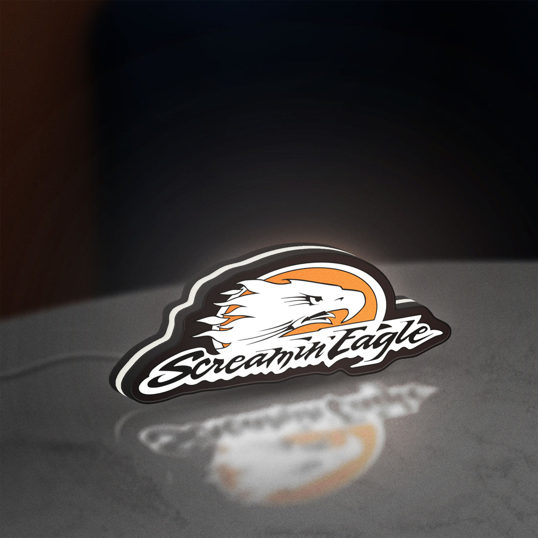 Screamin Eagle LED lightbox hanging on a wall with white glow