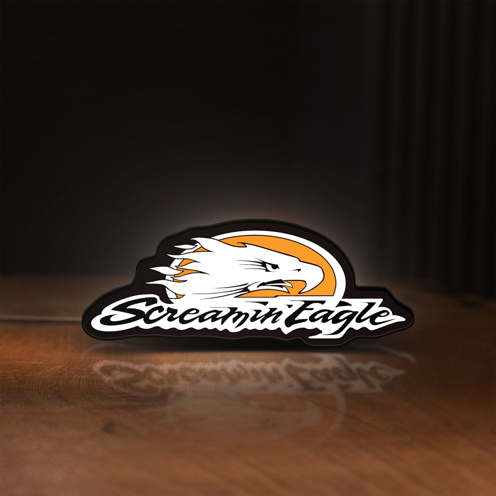 Front view of Screamin Eagle LED lightbox sign glowing on a wooden desk