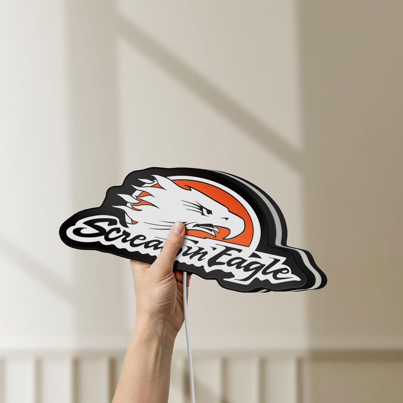 Unlit Screamin Eagle LED lightbox held by hand to show size and details