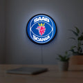 SAAB Scania LED lightbox hanging on a room wall with soft blue light