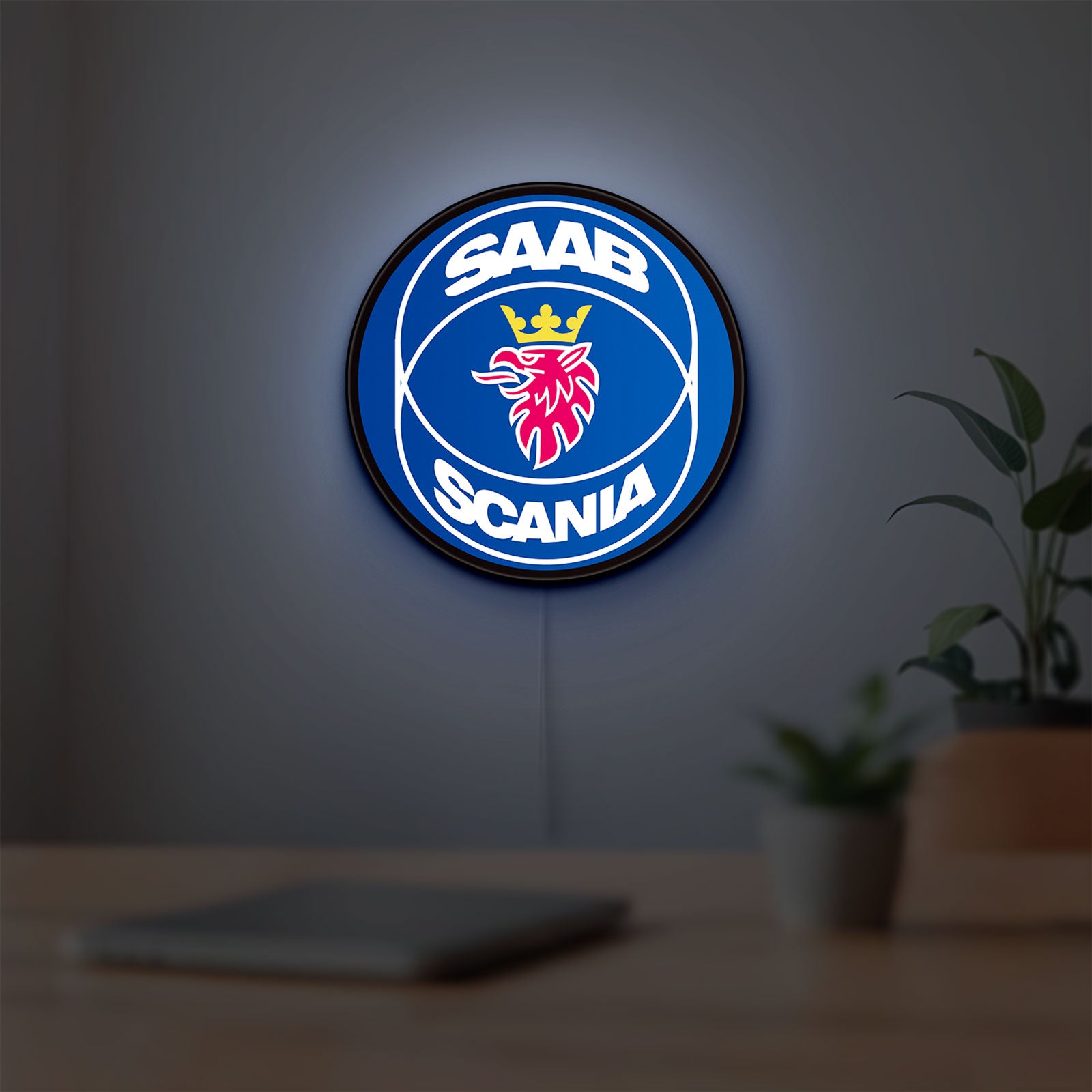 SAAB Scania LED lightbox hanging on a room wall with soft blue light