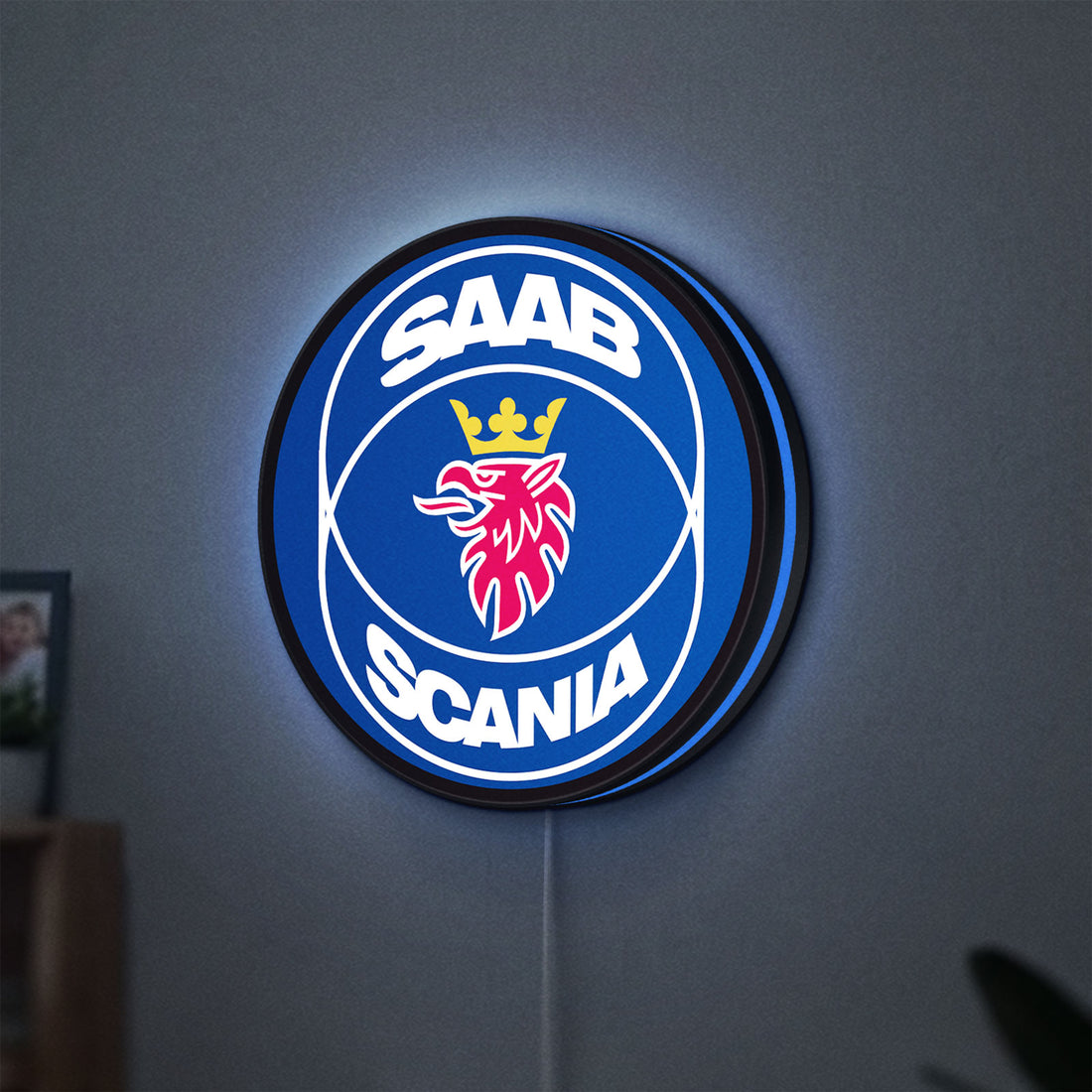SAAB Scania LED lightbox hanging on a wall with blue glow