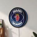 Unlit SAAB Scania LED lightbox mounted on a wall in daylight