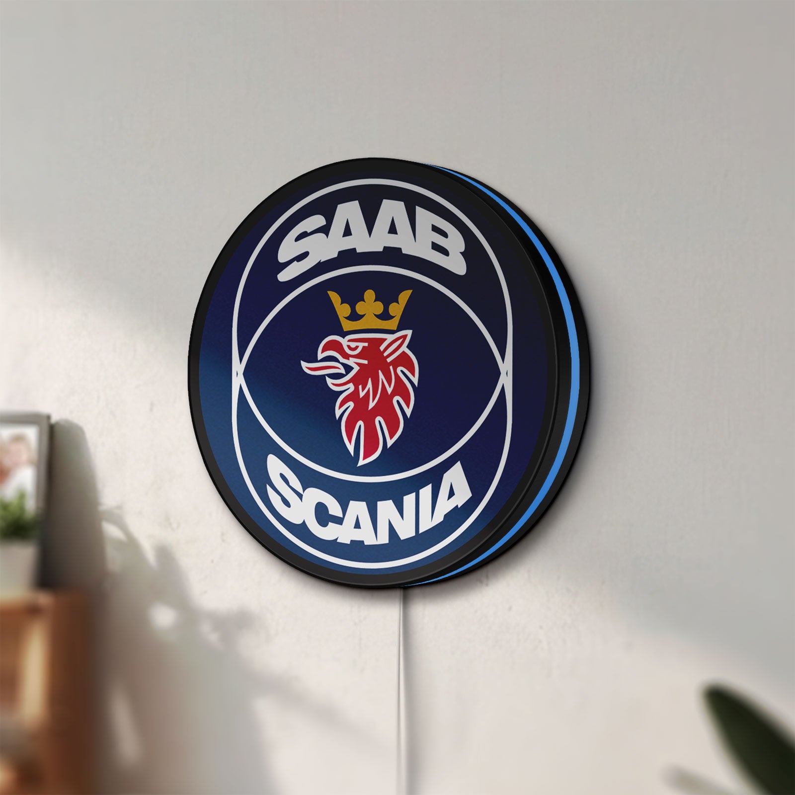 Unlit SAAB Scania LED lightbox mounted on a wall in daylight