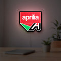 Aprilia LED lightbox hanging on a room wall with soft red light