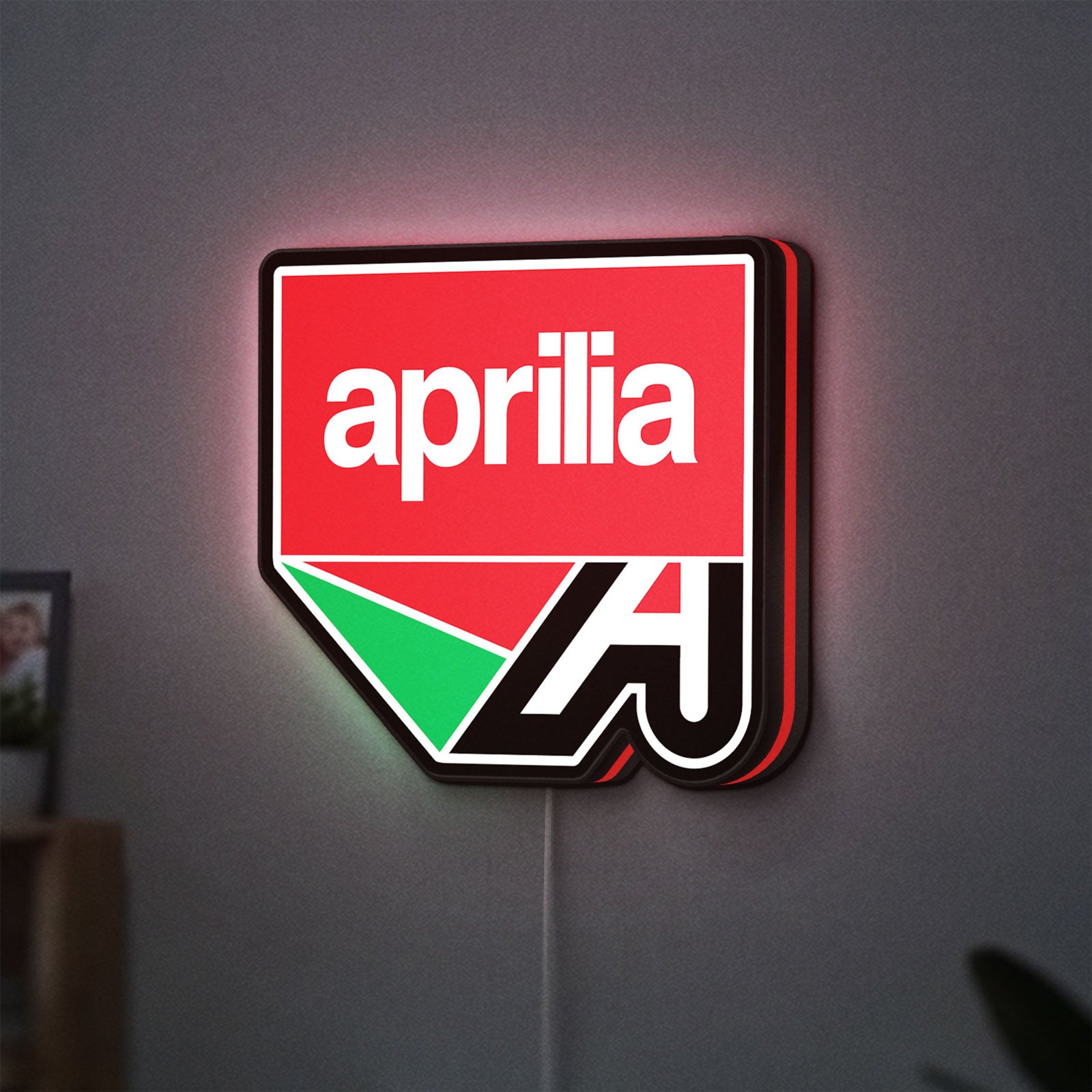 Aprilia LED lightbox hanging on a wall with red glow