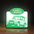 Front view of Land Rover Discovery LED lightbox sign glowing on a wooden desk