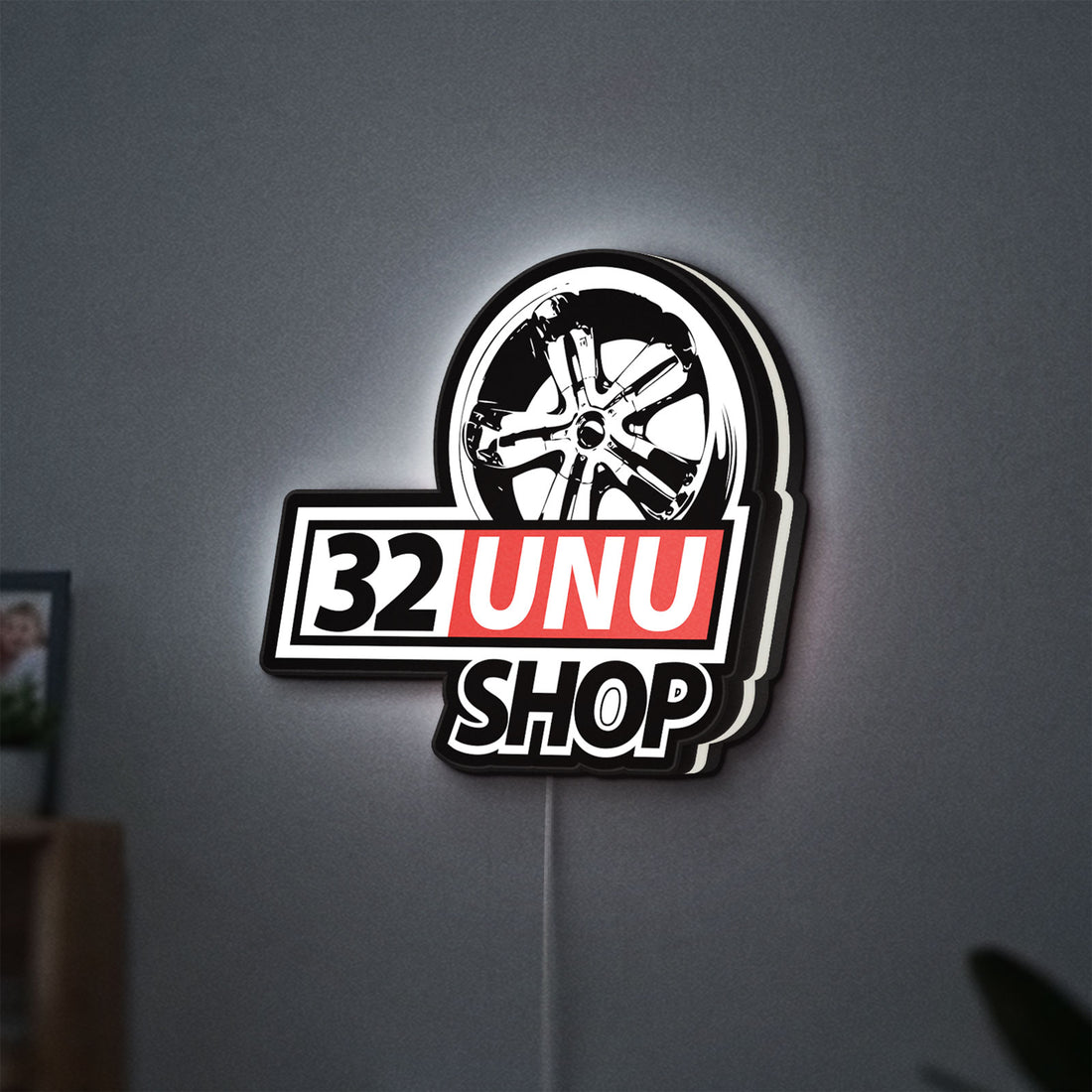32UNU SHOP LED lightbox hanging on a wall with white glow