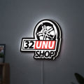 32UNU SHOP LED lightbox hanging on a wall with white glow