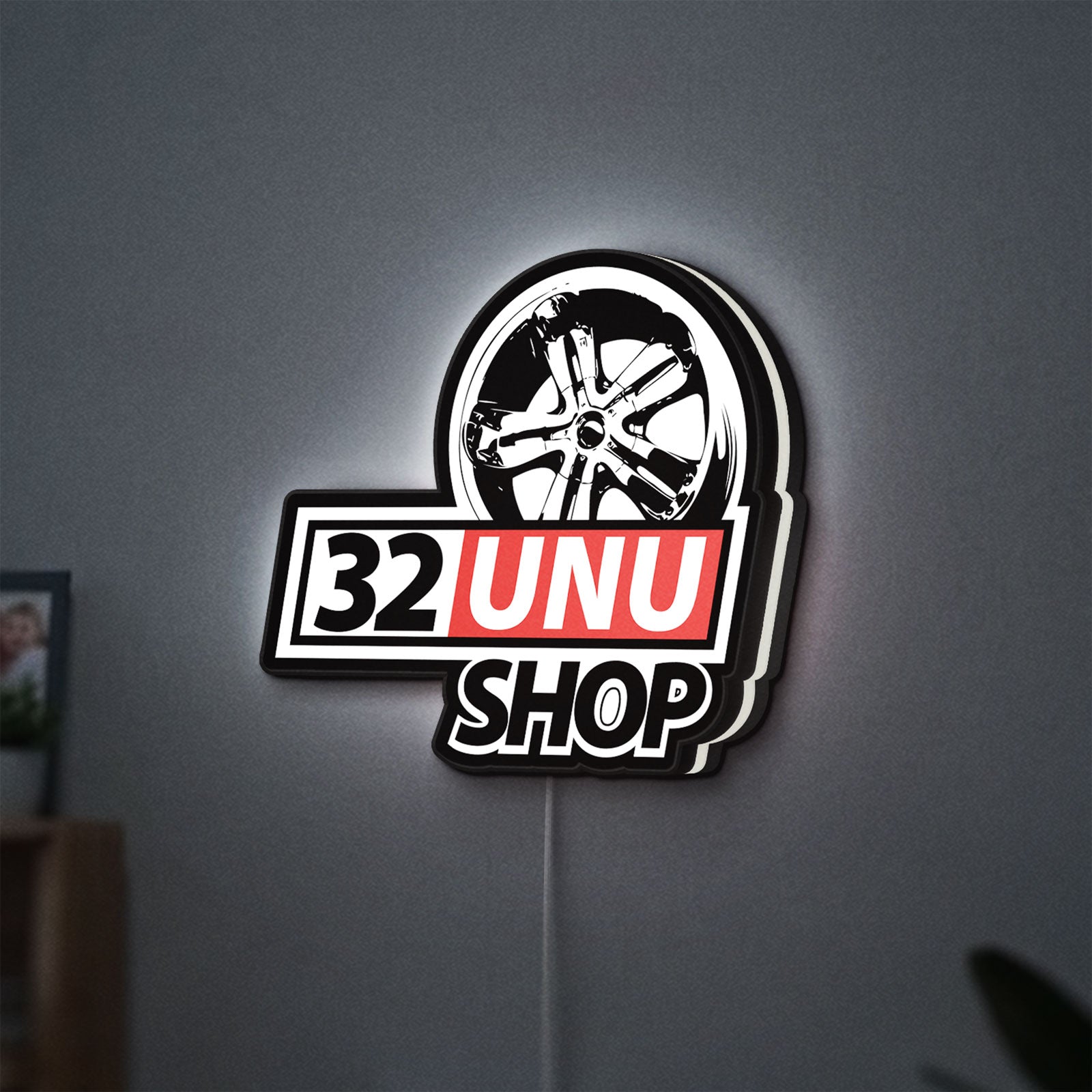 32UNU SHOP LED lightbox hanging on a wall with white glow