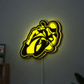 Ting'Avert Moto LED lightbox hanging on a wall with yellow glow