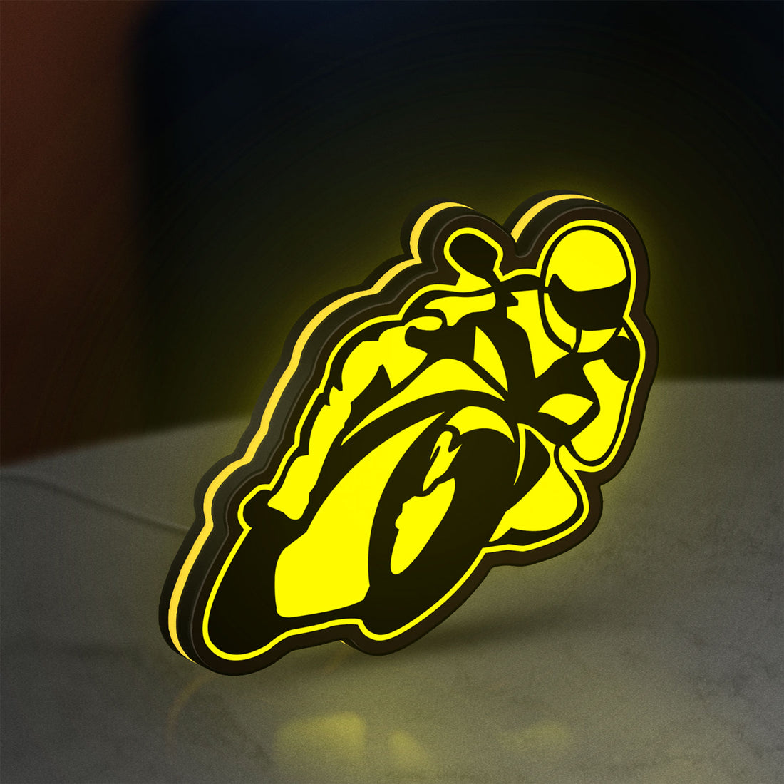 Ting'Avert Moto LED lightbox hanging on a wall with yellow glow